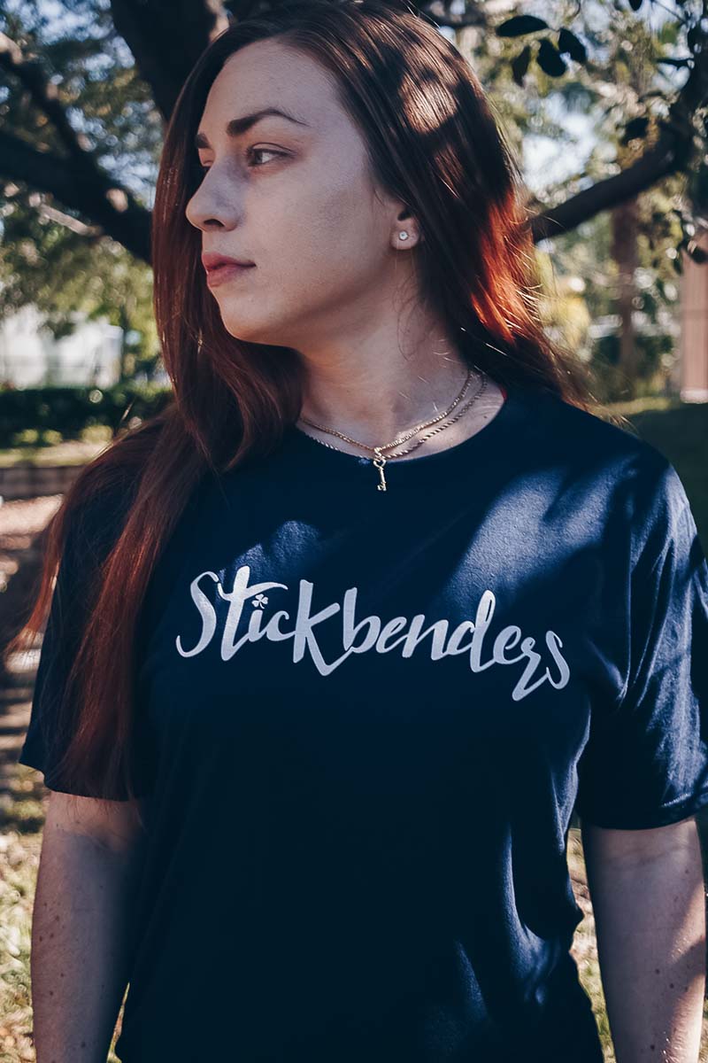 Woman wearing a branded t-shirt, representing bold sporty typography for team apparel.