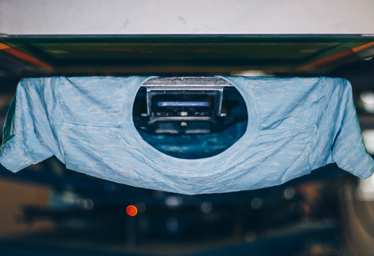 A screen-printed shirt being peeled off the press after printing